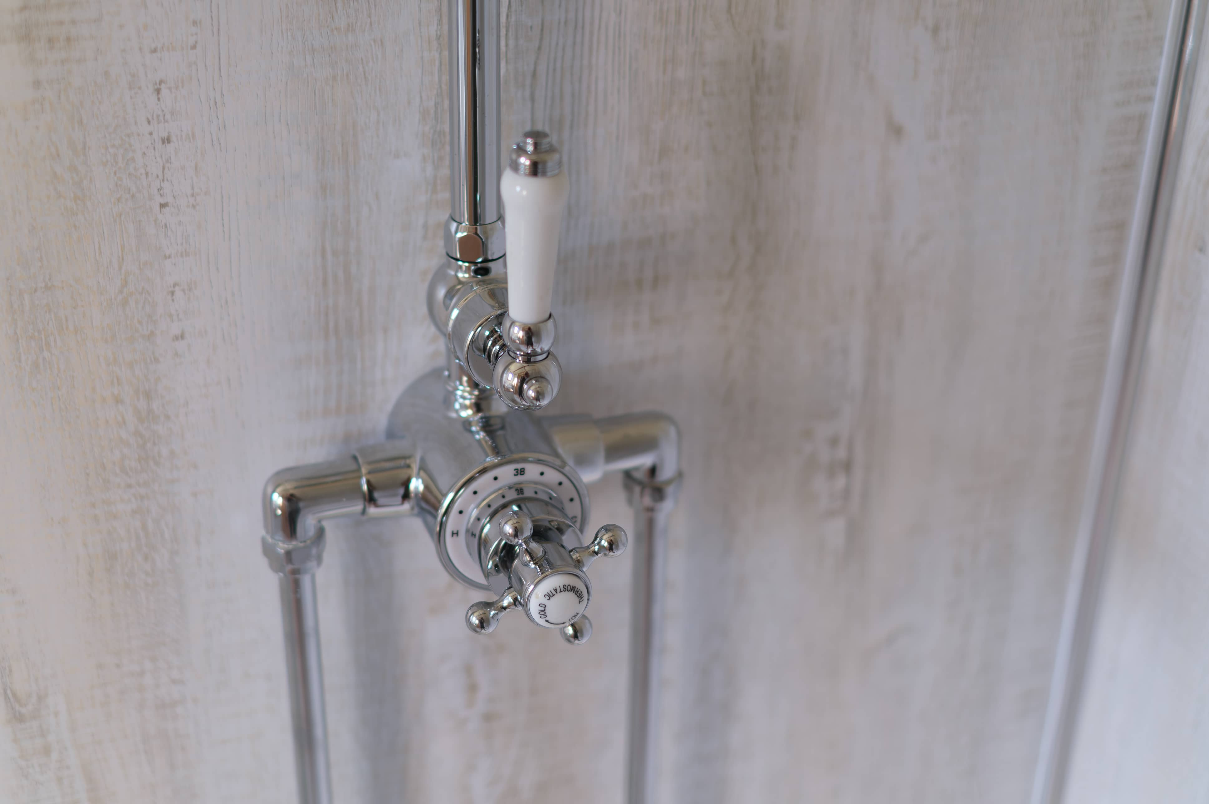 Close up of classic shower temperature hardware