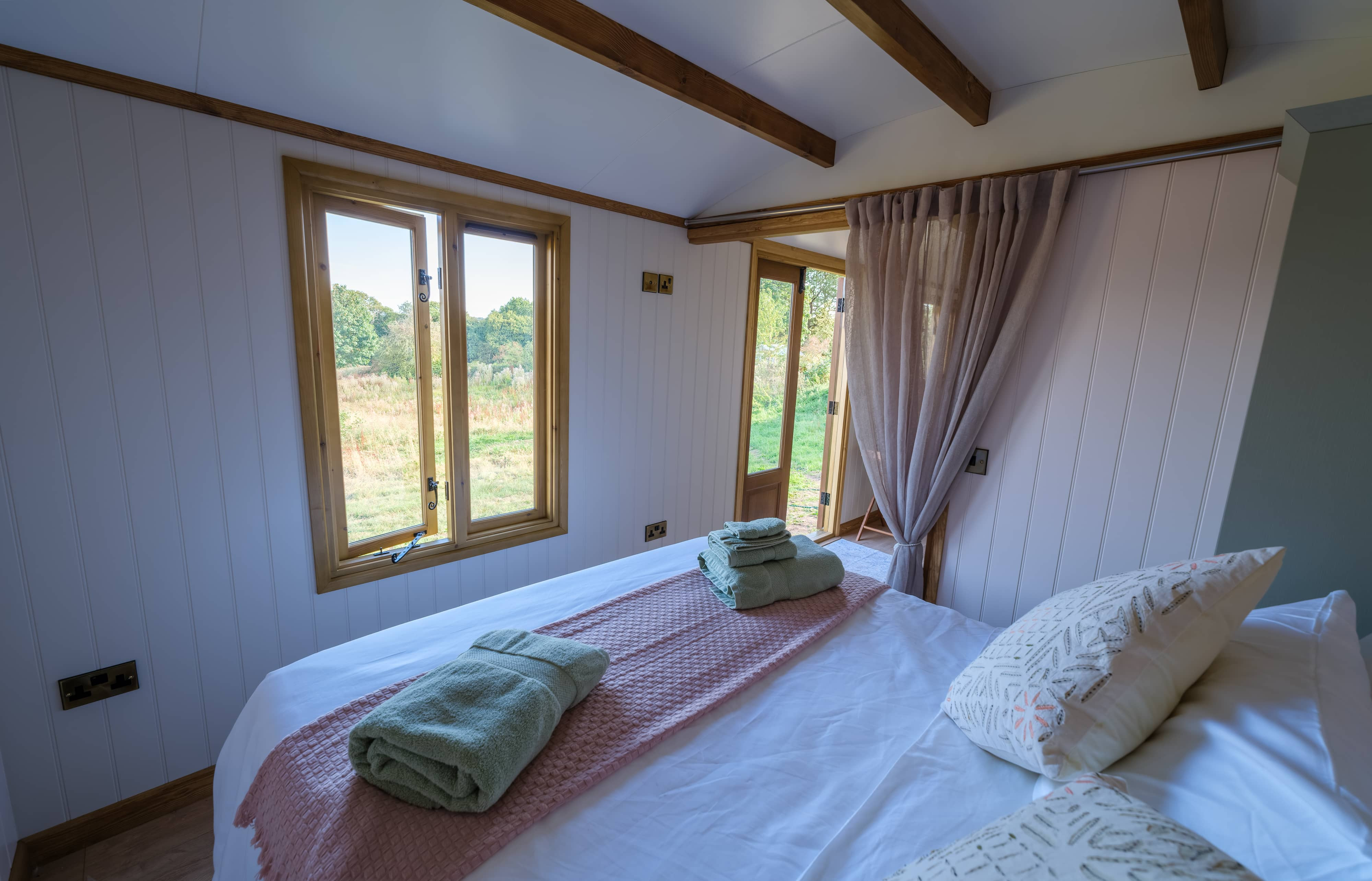 Looking down the corridor showing the bed and living space
