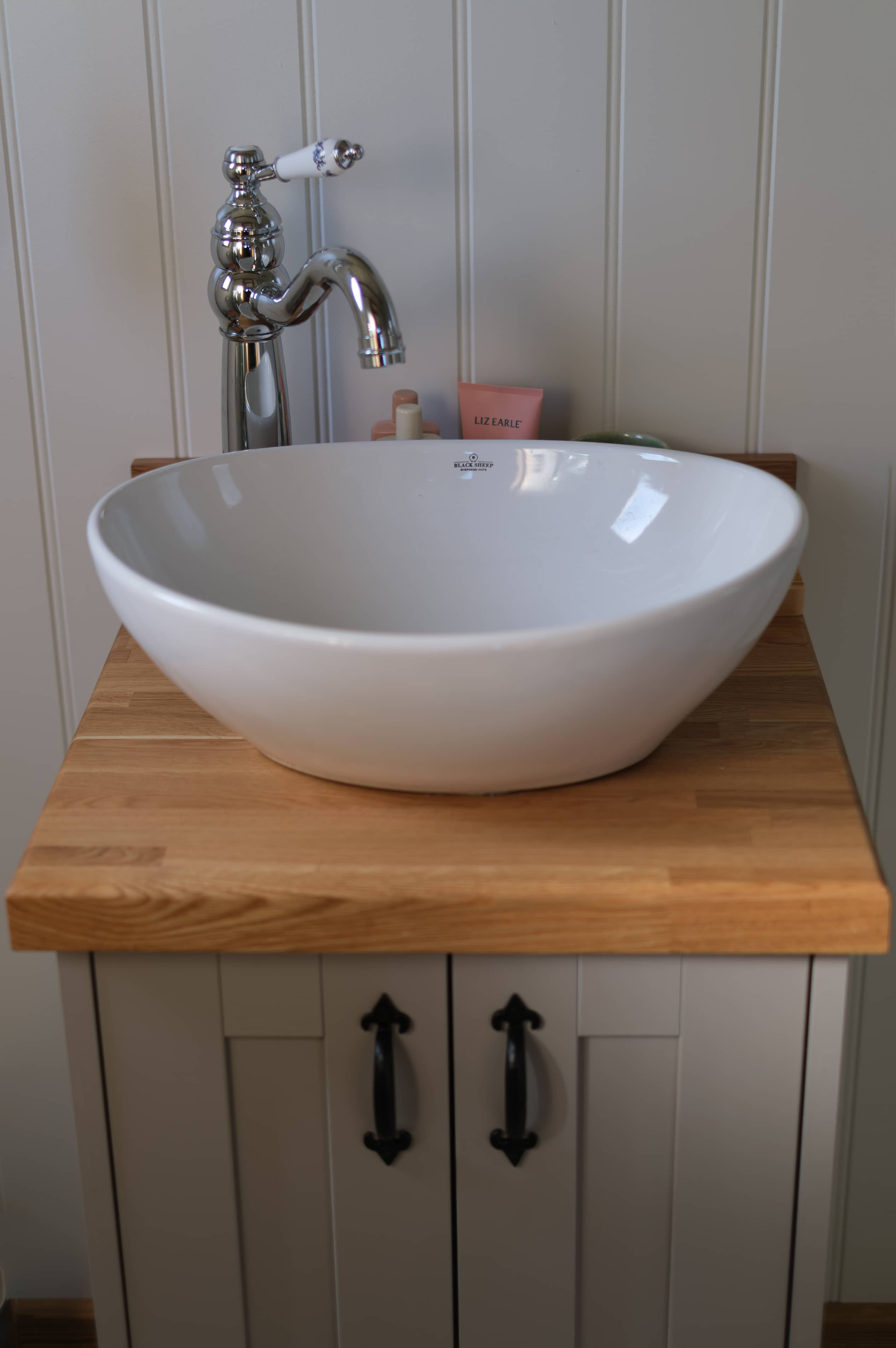 White ceramic basin with bronze traditional hardware